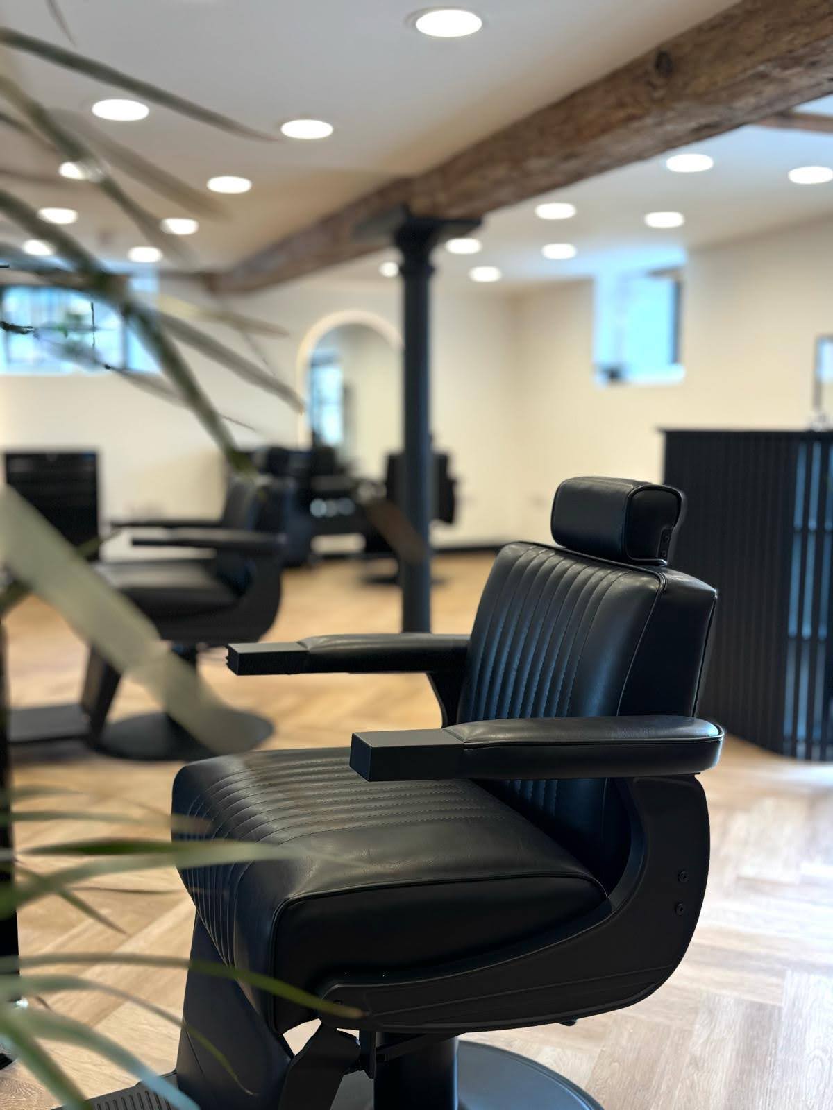 Barber adjusting client's beard